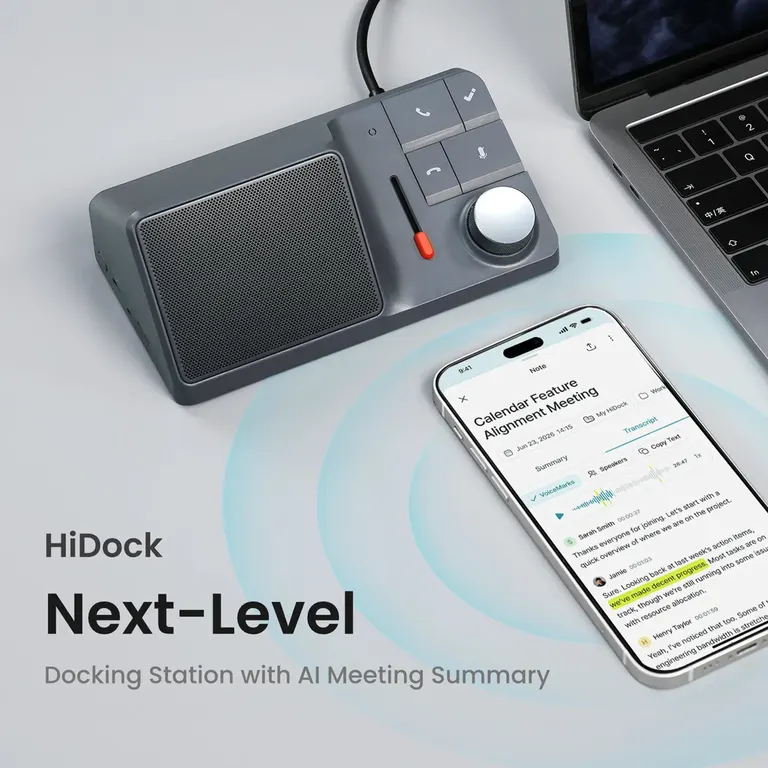 HiDock H1 audio dock on a desk beside a laptop and phone.